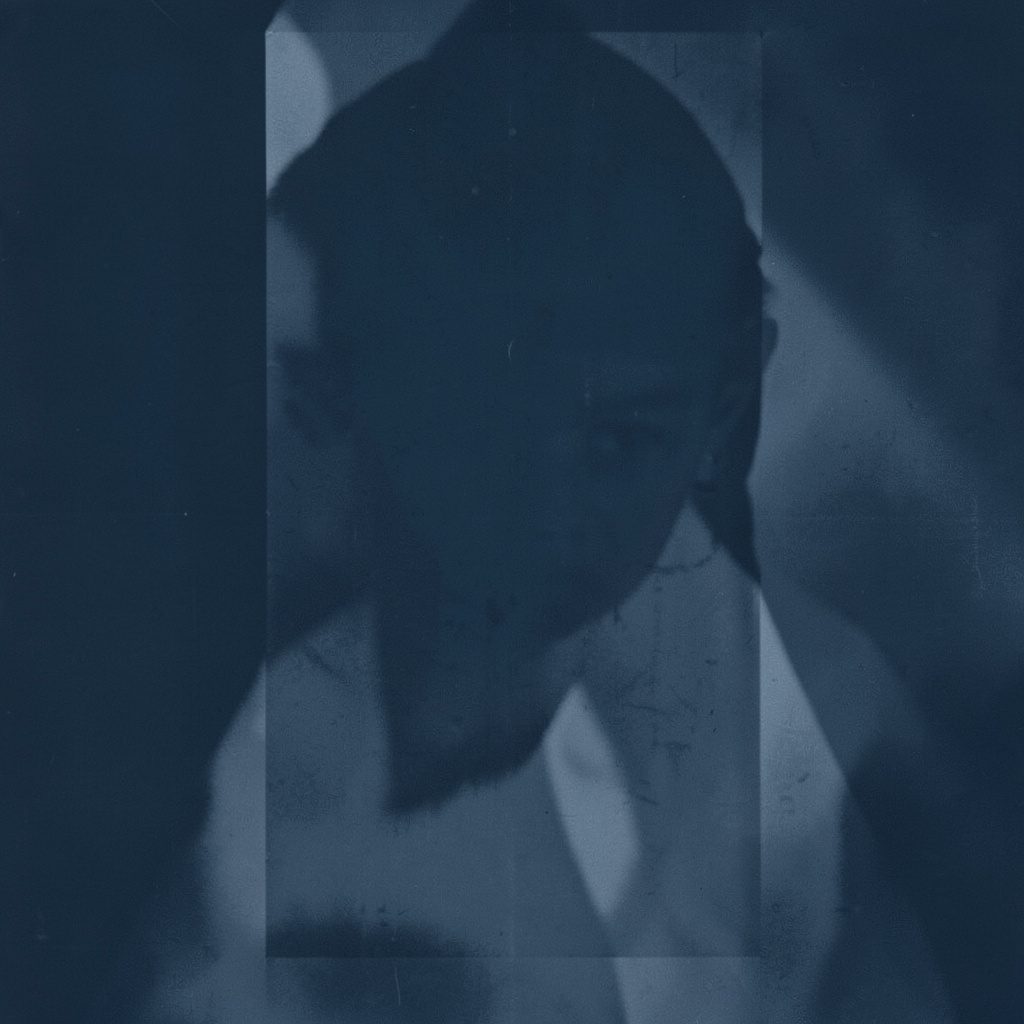 Duotone portrait silhouette in navy and white, head and shoulders of an unidentified professional figure